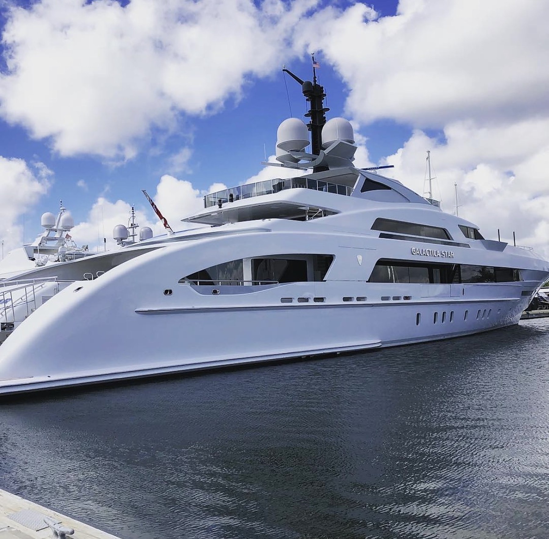 Large white motor yacht docked at a South Florida marina